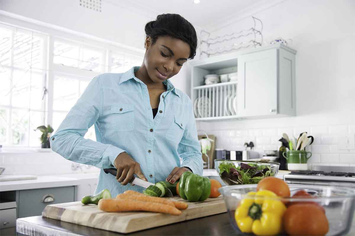 Woman cutting vegetables in a kitchen